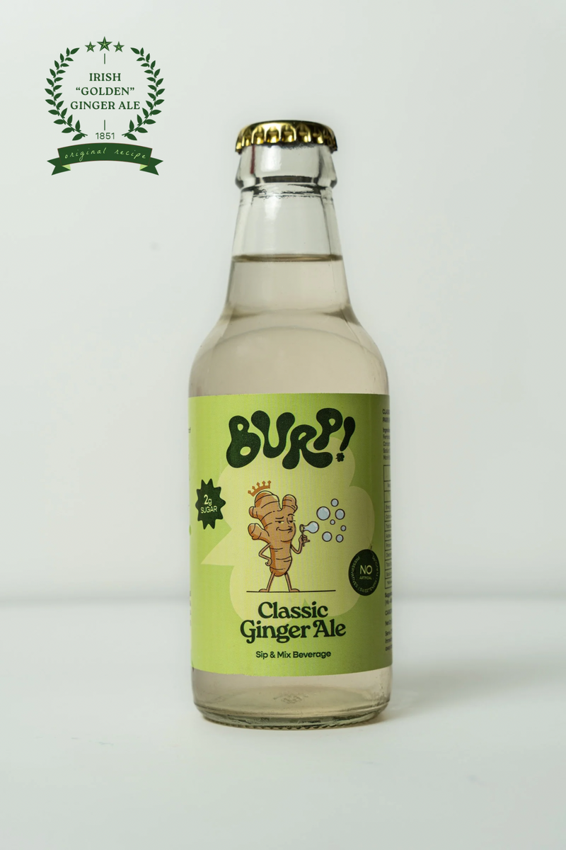 A bottle of BURP! Classic Ginger Ale on a light gray background, featuring a light green label with a cartoon ginger root character and a gold crown cap.